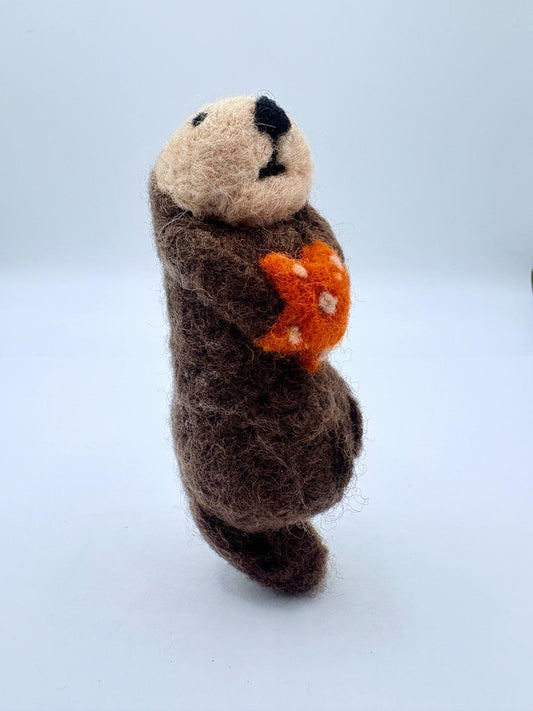 Otter with orange sea star
